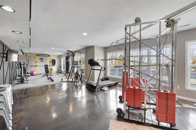 gym with recessed lighting, visible vents, a textured ceiling, and baseboards