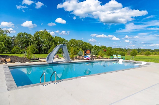 pool with a patio and a water slide