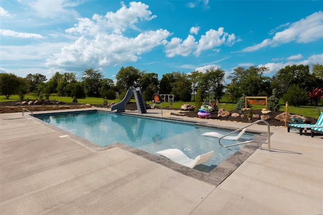 pool featuring a patio area and a water slide