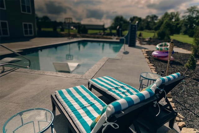 outdoor pool with a patio area