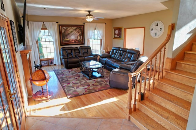 living room with light tile patterned floors and ceiling fan