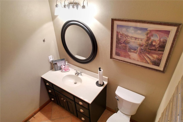 bathroom featuring tile patterned floors, vanity, and toilet