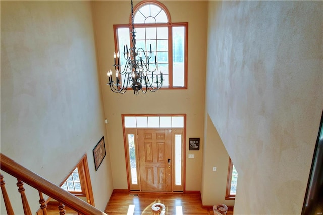 foyer entrance featuring a high ceiling and light hardwood / wood-style flooring