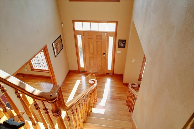 entrance foyer with light wood-type flooring and a high ceiling