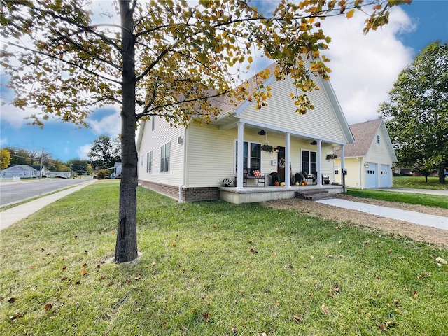 view of front of house featuring a front lawn, a garage, and covered porch