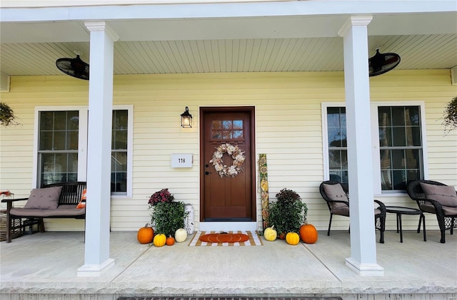 view of exterior entry featuring covered porch