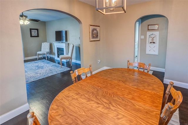 dining space featuring dark wood-type flooring and ceiling fan