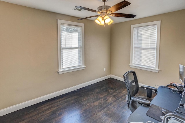 home office with dark wood-type flooring and ceiling fan