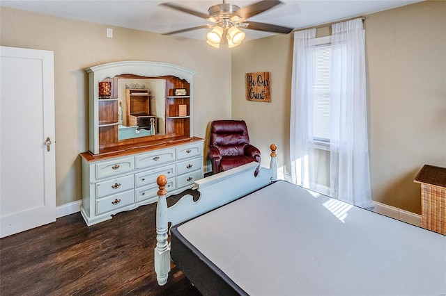 bedroom with dark hardwood / wood-style flooring and ceiling fan