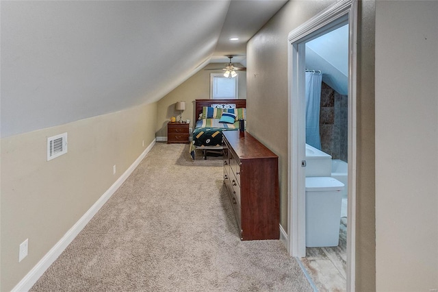 carpeted home office with ceiling fan and vaulted ceiling