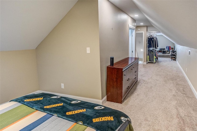 additional living space featuring light colored carpet and vaulted ceiling