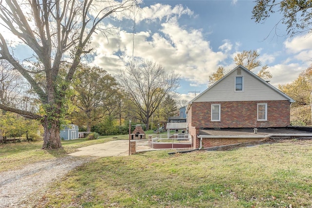 view of side of property with a lawn and a patio area