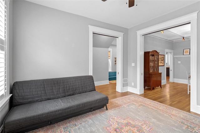 sitting room with wood-type flooring and ceiling fan