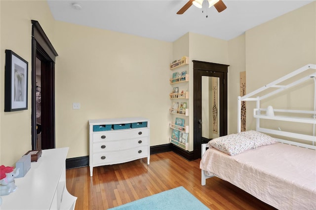 bedroom with ceiling fan and wood-type flooring