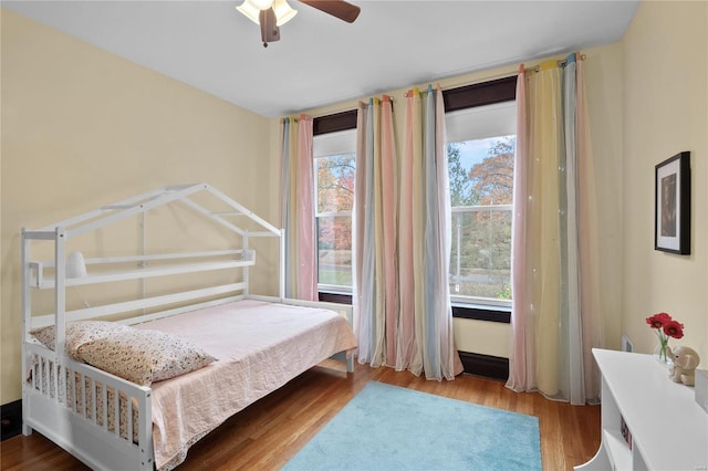 bedroom with ceiling fan and light wood-type flooring