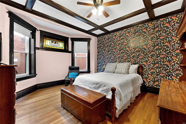 bedroom featuring ceiling fan, crown molding, coffered ceiling, and light wood-type flooring