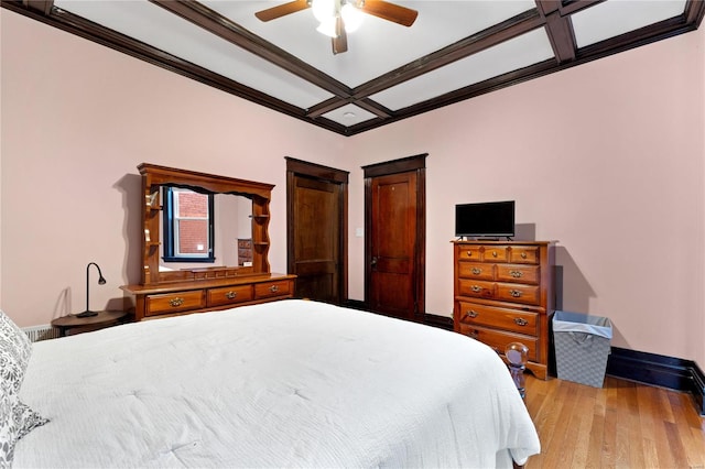 bedroom with ornamental molding, light hardwood / wood-style floors, ceiling fan, and coffered ceiling