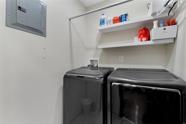 washroom with independent washer and dryer and electric panel