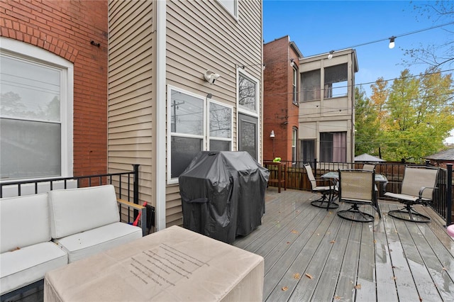 wooden terrace featuring outdoor lounge area and a grill