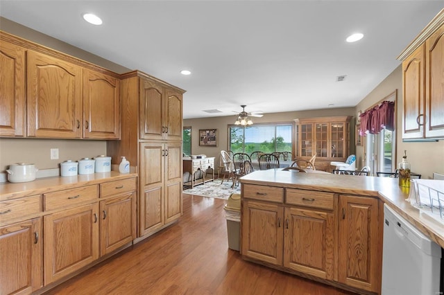 kitchen with kitchen peninsula, light hardwood / wood-style floors, ceiling fan, and dishwasher