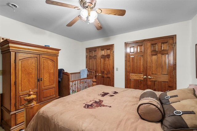 bedroom featuring ceiling fan and two closets