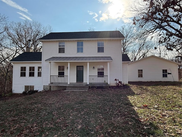 view of front of house featuring covered porch and a front yard