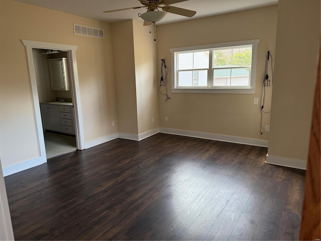 empty room with dark hardwood / wood-style floors, ceiling fan, and sink