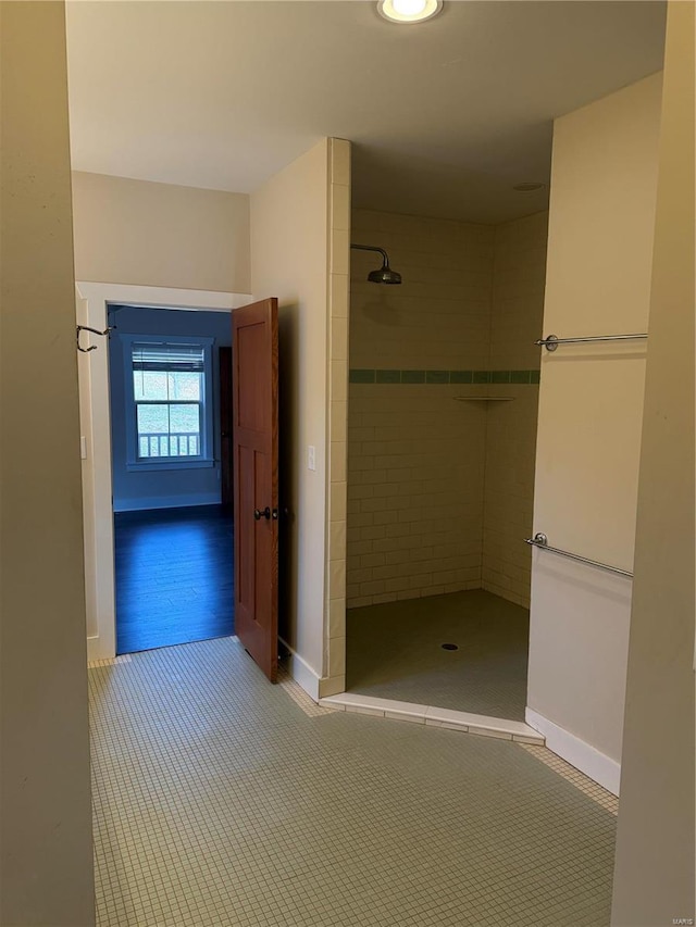 bathroom featuring wood-type flooring and tiled shower