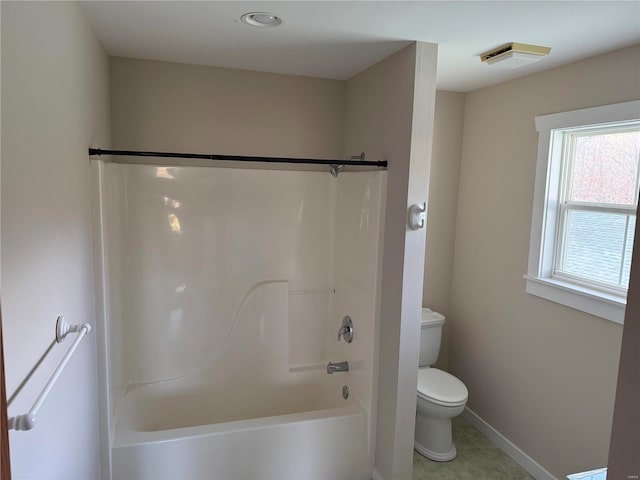 bathroom featuring tile patterned flooring, toilet, and shower / bathtub combination