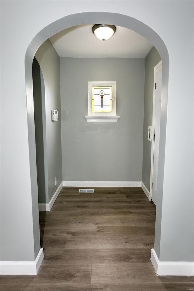 corridor featuring dark hardwood / wood-style floors