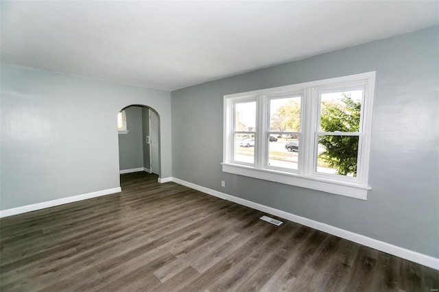 spare room with dark hardwood / wood-style flooring