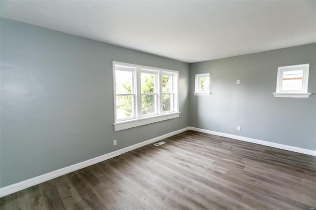 unfurnished room with dark hardwood / wood-style floors