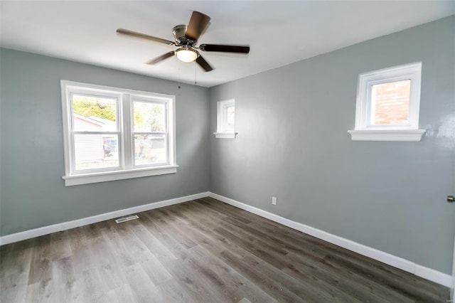 spare room with hardwood / wood-style flooring and ceiling fan