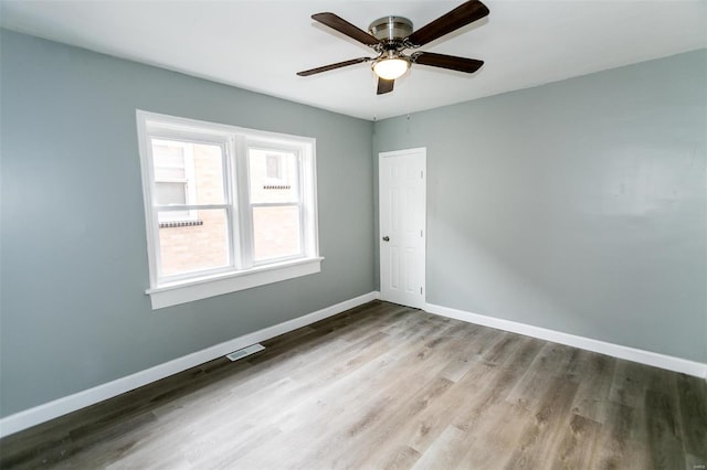 spare room with ceiling fan and light hardwood / wood-style flooring