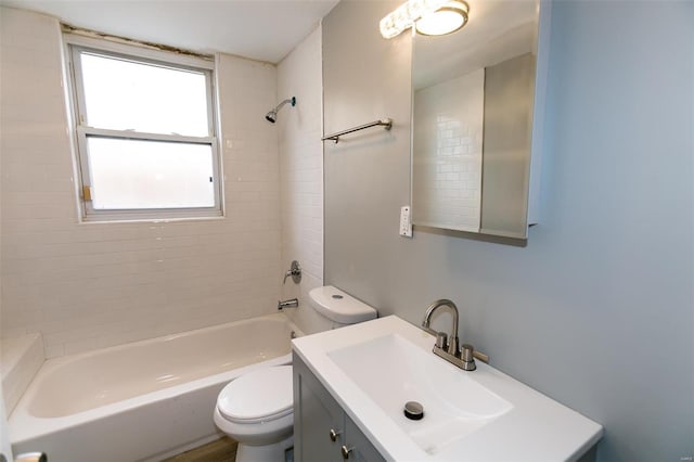 full bathroom with vanity, tiled shower / bath, and toilet