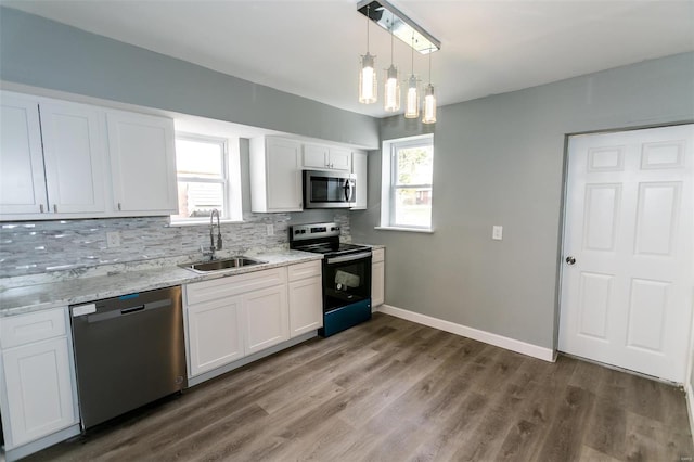 kitchen featuring stainless steel appliances, dark wood-type flooring, sink, tasteful backsplash, and white cabinetry