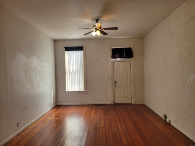 unfurnished room featuring ceiling fan and dark hardwood / wood-style floors