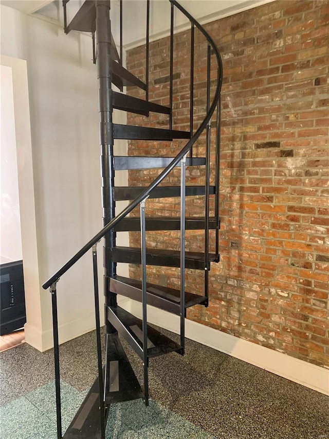 staircase with brick wall