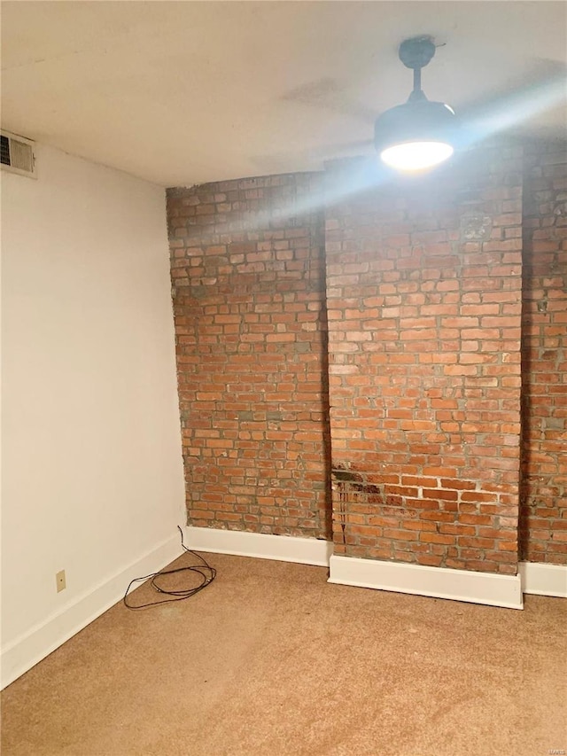 empty room with brick wall and carpet