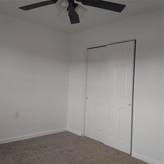 unfurnished bedroom featuring ceiling fan, carpet flooring, and a closet