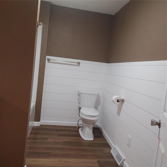 bathroom featuring hardwood / wood-style flooring and toilet