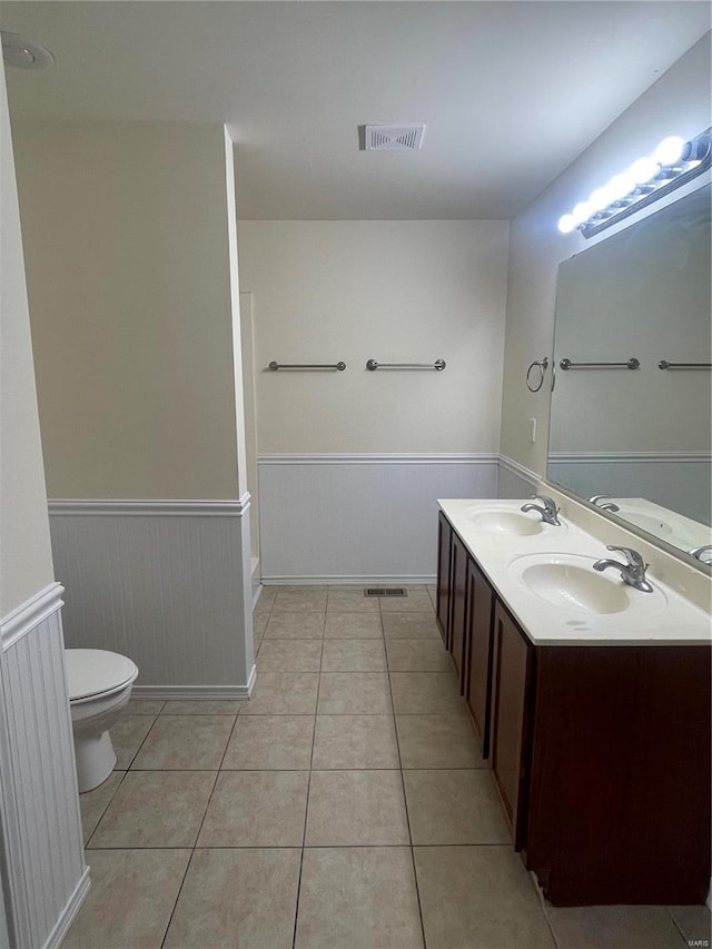 bathroom with vanity, toilet, and tile patterned floors