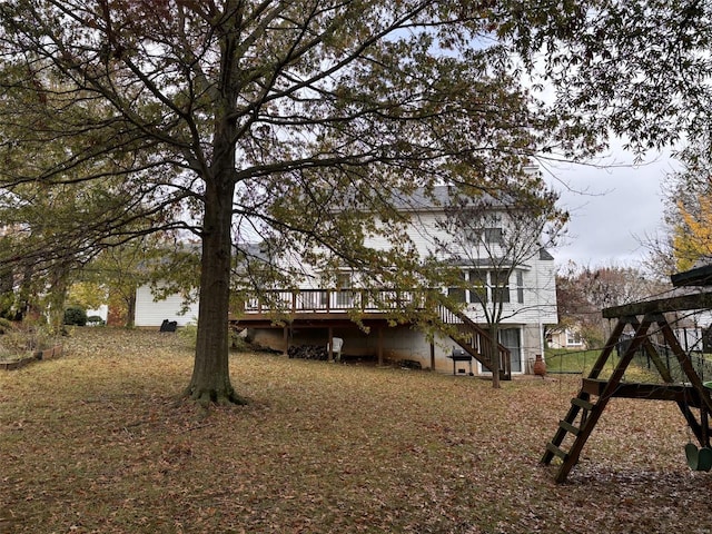 rear view of house featuring a wooden deck