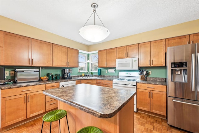 kitchen with a center island, hanging light fixtures, light parquet floors, white appliances, and a kitchen bar