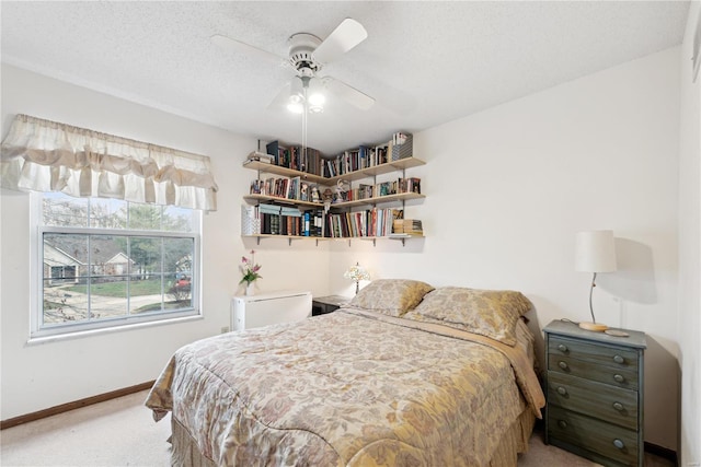 bedroom featuring carpet, a textured ceiling, and ceiling fan