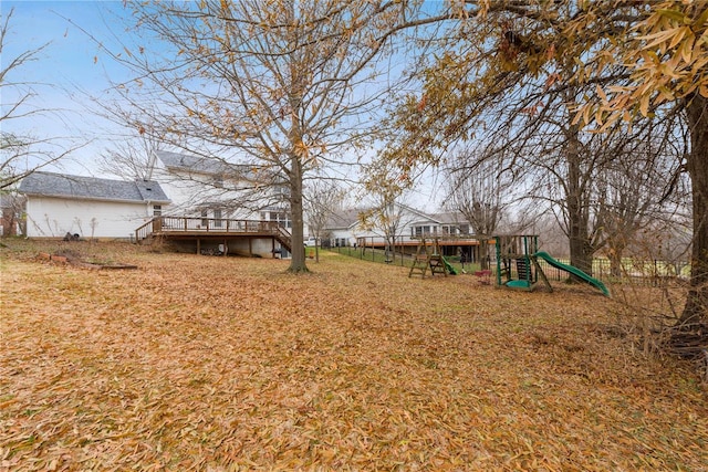 view of yard featuring a playground and a wooden deck