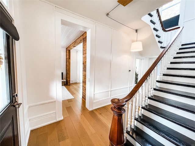 stairs featuring hardwood / wood-style flooring