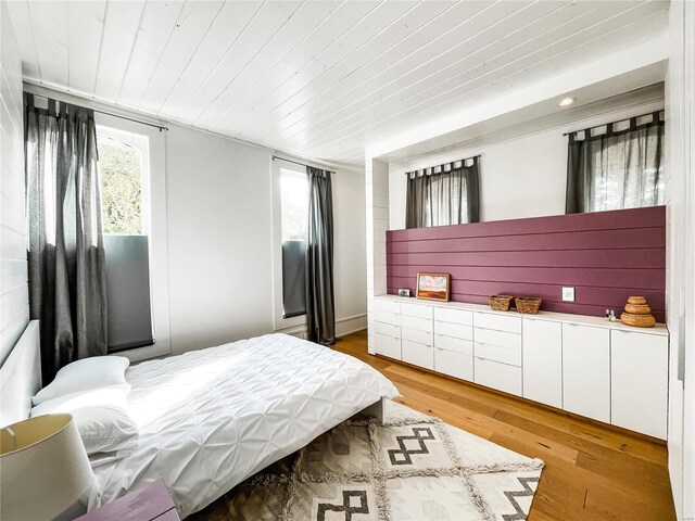 bedroom with light hardwood / wood-style floors and wood ceiling