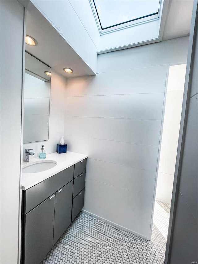 bathroom with vanity and a skylight