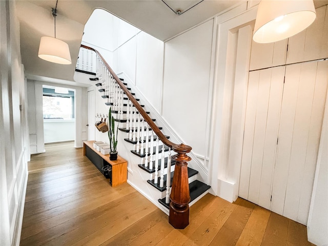 stairs with hardwood / wood-style floors